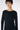 Woman wearing a black long-sleeve top against a white background